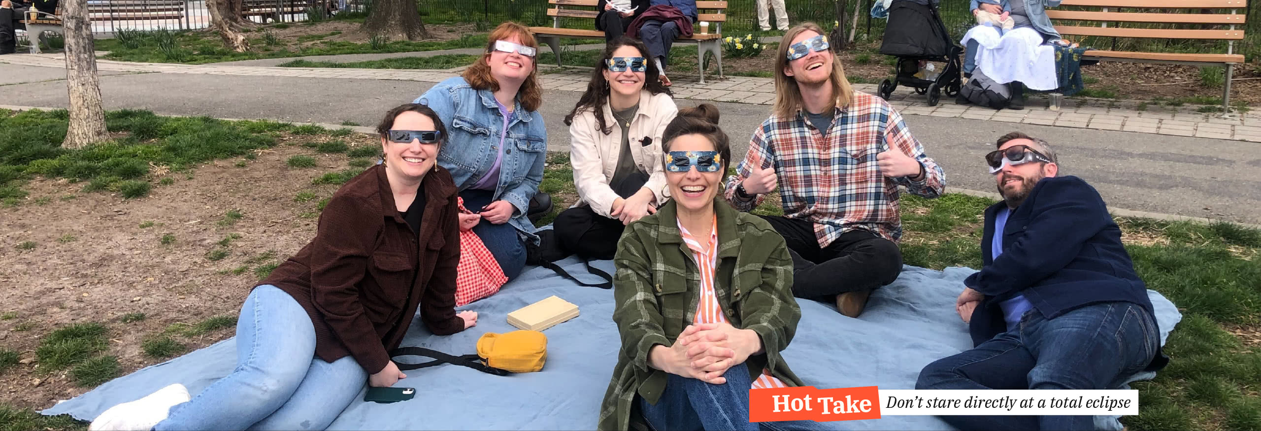 The HelpGood East Team wearing eclipse glasses, safely enjoying a total eclipse of the sun.  Hot Take: Don't stare directly at a total eclipse.